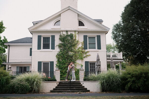 Mitchell and Kathleen smiling together outside the house