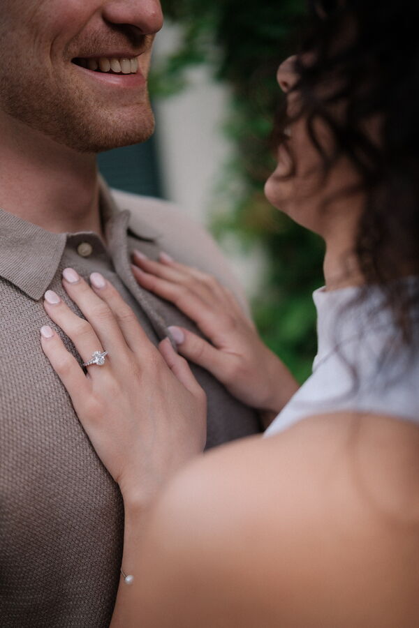 Kathleen showing off her engagement ring while Mitchell hugs her