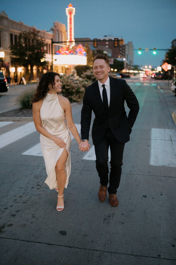 Mitchell and Kathleen walking hand in hand down the street